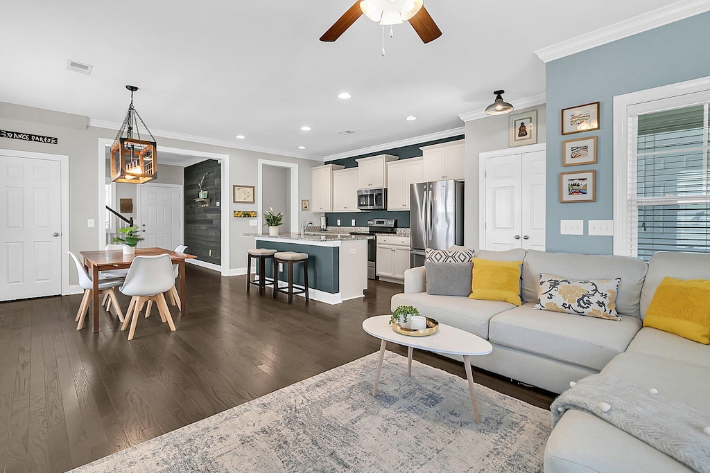 4235 Scharite St, Charleston, SC 29414 - living area featuring ornamental molding, a ceiling fan, recessed lighting, dark wood-style floors, and baseboards