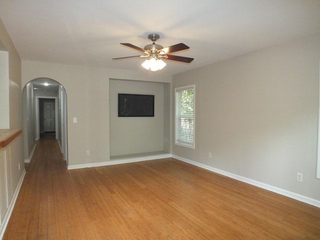 418 Meritta Ave, Beaufort, SC 29902 - spare room featuring arched walkways, light wood finished floors, a ceiling fan, and baseboards