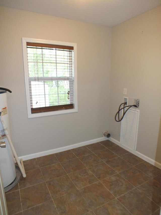 418 Meritta Ave, Beaufort, SC 29902 - laundry room with washer hookup, water heater, dark tile patterned floors, and baseboards