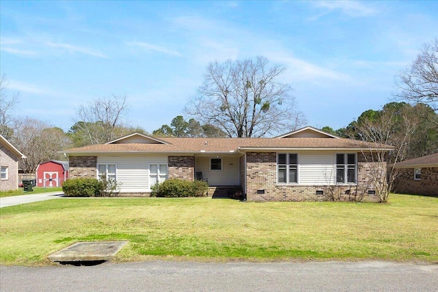 single story home featuring crawl space, an outbuilding, brick siding, and a front yard