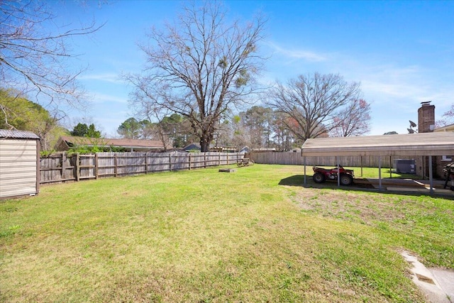 view of yard with an outbuilding, a storage unit, and a fenced backyard