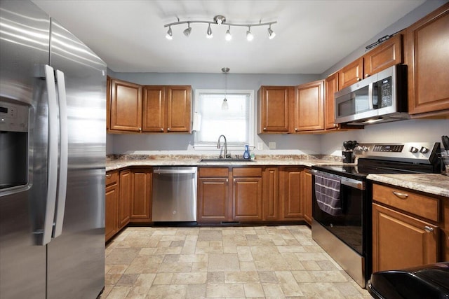 kitchen featuring a sink, brown cabinetry, and stainless steel appliances