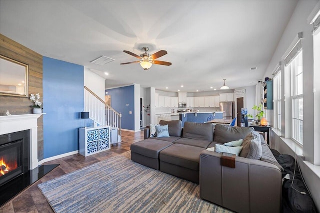 707 Redbud Ln, Summerville, SC 29486 - living area with wood walls, visible vents, a glass covered fireplace, ceiling fan, and wood finished floors