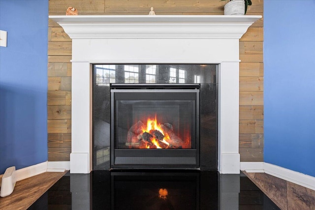 707 Redbud Ln, Summerville, SC 29486 - interior details featuring a warm lit fireplace and wood walls