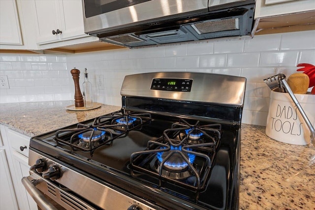 707 Redbud Ln, Summerville, SC 29486 - kitchen with tasteful backsplash, light stone counters, white cabinets, and stainless steel appliances