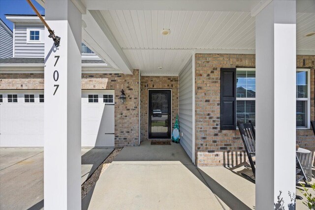 707 Redbud Ln, Summerville, SC 29486 - entrance to property featuring brick siding, a porch, and an attached garage