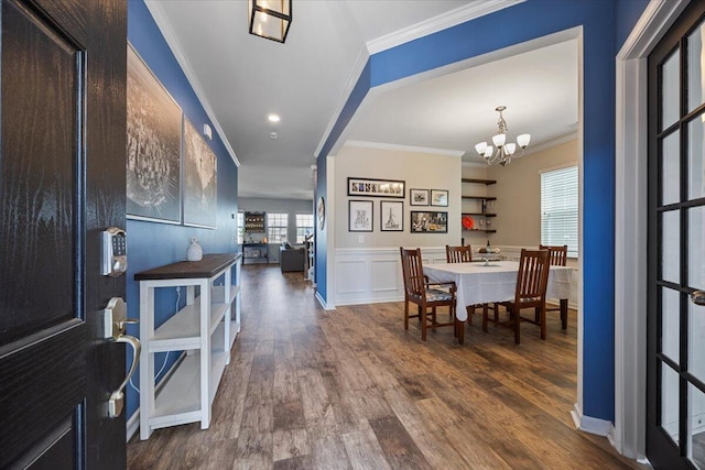 707 Redbud Ln, Summerville, SC 29486 - interior space featuring a wainscoted wall, a decorative wall, crown molding, wood finished floors, and a notable chandelier