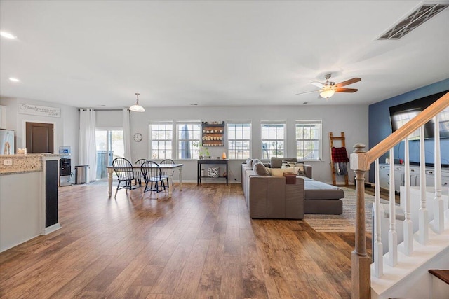 707 Redbud Ln, Summerville, SC 29486 - living room with stairs, visible vents, wood finished floors, and a ceiling fan