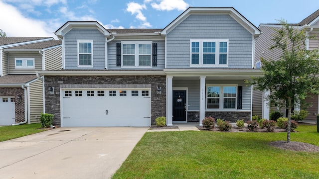 5138 Preserve Blvd, Ladson, SC 29456 - view of front facade featuring stone siding, a front yard, driveway, an attached garage, and a porch