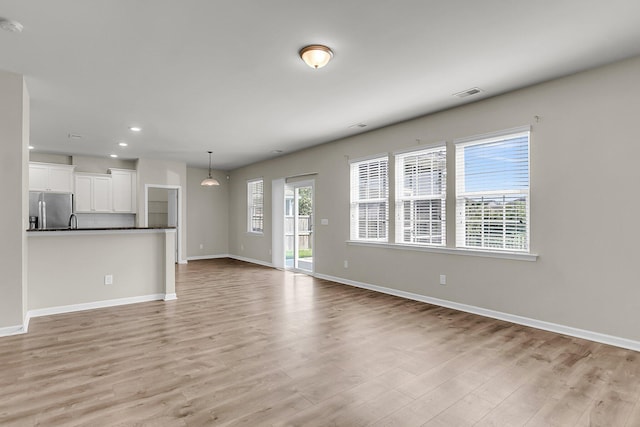 5138 Preserve Blvd, Ladson, SC 29456 - unfurnished living room featuring light wood-type flooring, baseboards, and recessed lighting