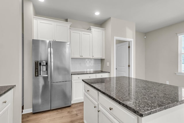 5138 Preserve Blvd, Ladson, SC 29456 - kitchen featuring stainless steel fridge, light wood-style floors, white cabinets, a kitchen island, and tasteful backsplash