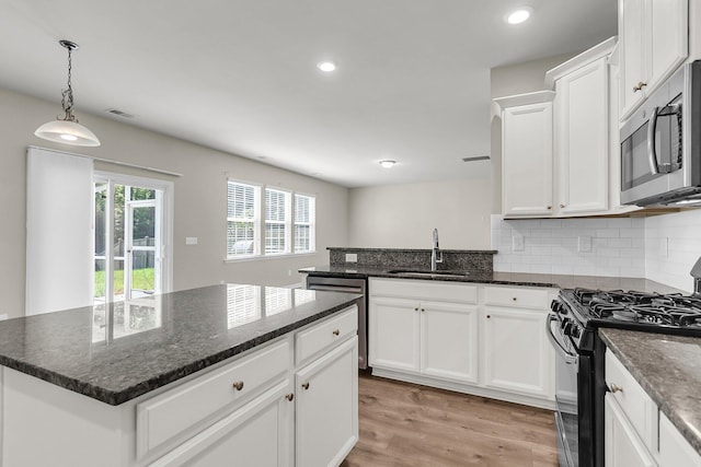 5138 Preserve Blvd, Ladson, SC 29456 - kitchen featuring stainless steel appliances, a sink, white cabinetry, light wood-style flooring, and a peninsula