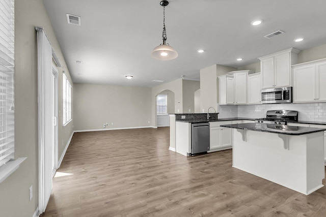 5138 Preserve Blvd, Ladson, SC 29456 - kitchen with appliances with stainless steel finishes, open floor plan, arched walkways, plenty of natural light, and recessed lighting