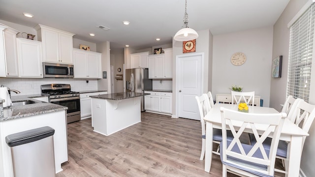 5138 Preserve Blvd, Ladson, SC 29456 - kitchen with appliances with stainless steel finishes, a sink, backsplash, white cabinets, and recessed lighting