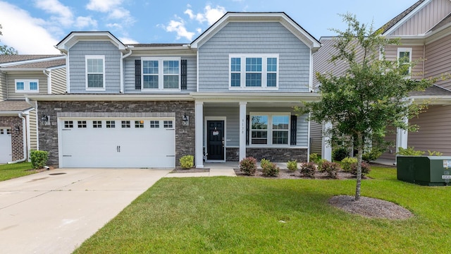 5138 Preserve Blvd, Ladson, SC 29456 - view of front of house featuring a front lawn, driveway, stone siding, an attached garage, and covered porch