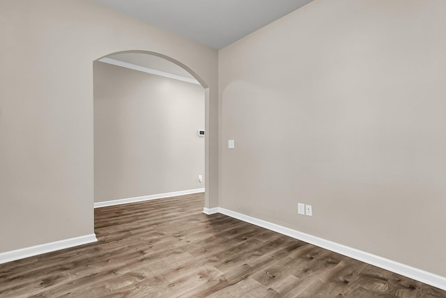 5138 Preserve Blvd, Ladson, SC 29456 - empty room featuring arched walkways, wood finished floors, and baseboards