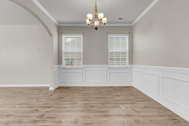 5138 Preserve Blvd, Ladson, SC 29456 - unfurnished dining area featuring arched walkways, a chandelier, plenty of natural light, wainscoting, and light wood finished floors