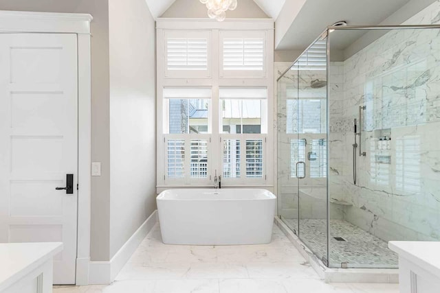 full bathroom featuring baseboards, a marble finish shower, vanity, a freestanding bath, and marble finish floor