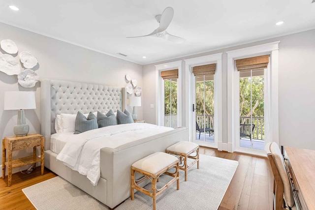 bedroom featuring hardwood / wood-style flooring, crown molding, access to exterior, and recessed lighting