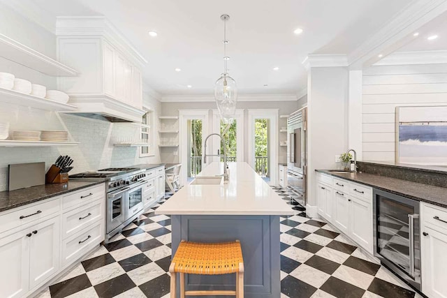 kitchen featuring a sink, range with two ovens, open shelves, and beverage cooler