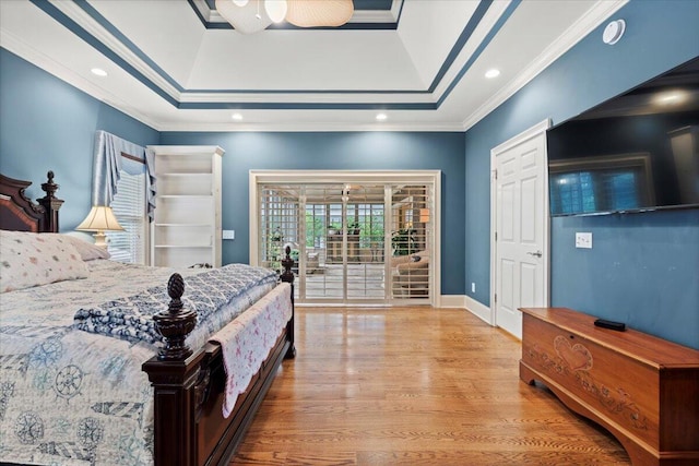 bedroom featuring crown molding, wood finished floors, recessed lighting, a raised ceiling, and baseboards