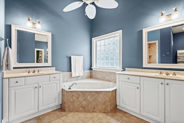 full bathroom with tile patterned floors, a garden tub, two vanities, and ceiling fan