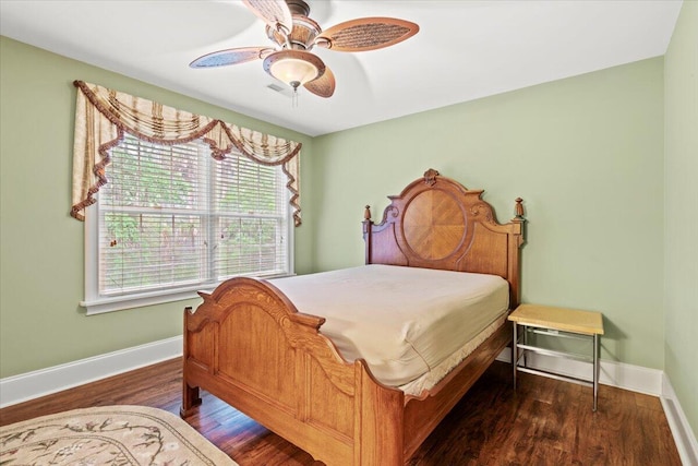 bedroom with baseboards, wood finished floors, and a ceiling fan