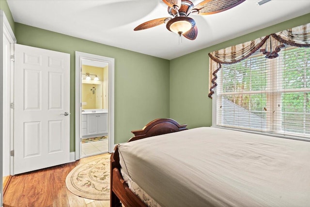 bedroom featuring wood finished floors, connected bathroom, and ceiling fan