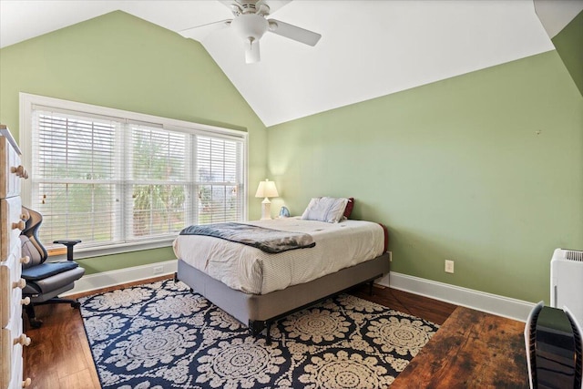 bedroom with baseboards, vaulted ceiling, wood finished floors, and ceiling fan