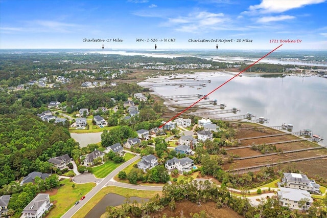 aerial view of property's location featuring a large body of water and nearby suburban area