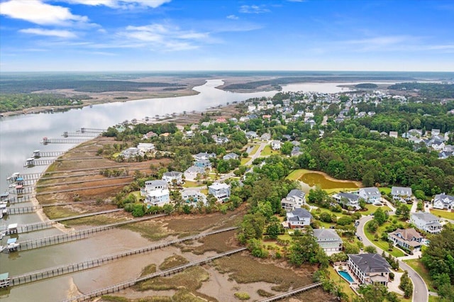 aerial view of property and surrounding area featuring a large body of water