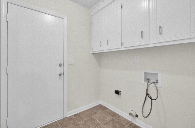 clothes washing area with washer hookup, hookup for a gas dryer, cabinet space, and baseboards