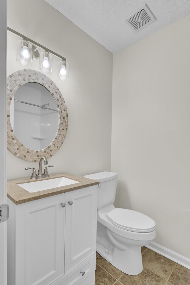 bathroom with visible vents, toilet, a textured ceiling, baseboards, and vanity