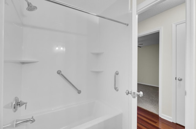 bathroom with wood finished floors and bathtub / shower combination