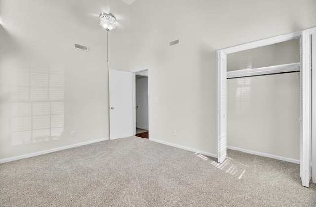 unfurnished bedroom featuring a closet, visible vents, and carpet floors