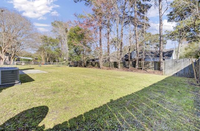 view of yard with cooling unit and a fenced backyard