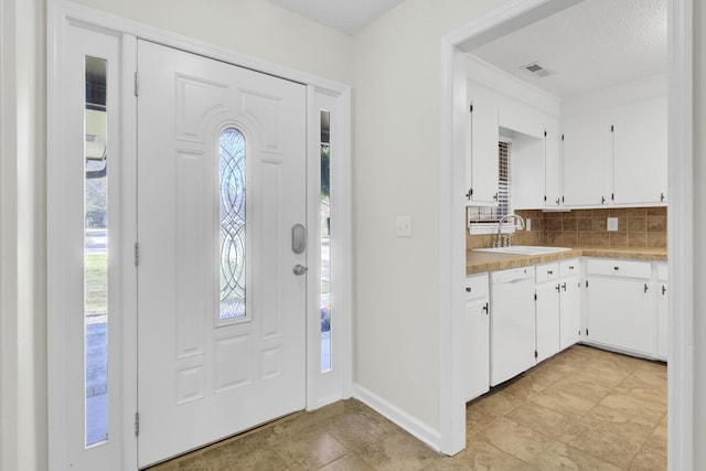 entrance foyer featuring visible vents and baseboards