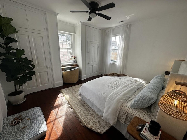 bedroom with ceiling fan, hardwood / wood-style floors, and crown molding