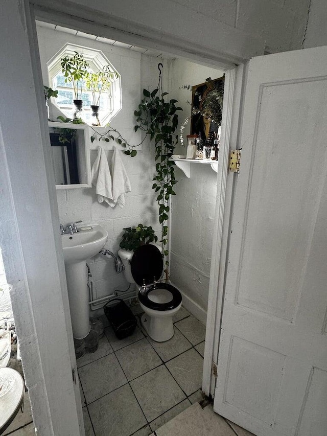 bathroom featuring tile patterned flooring and toilet