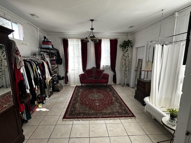 walk in closet with light tile patterned floors