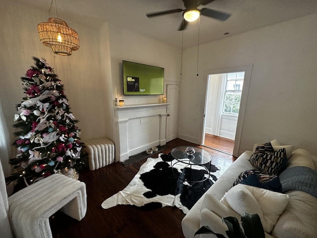 living room featuring ceiling fan and hardwood / wood-style flooring