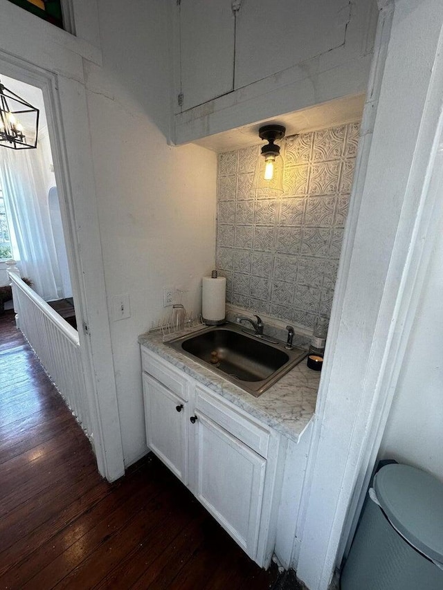 bathroom with vanity, wood-type flooring, toilet, and a notable chandelier