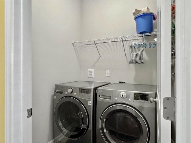 washroom featuring washer and clothes dryer