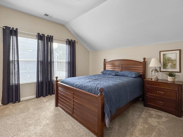 bedroom featuring lofted ceiling and light colored carpet