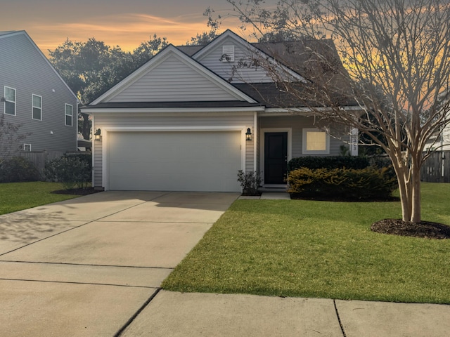 view of front of house with a garage and a lawn