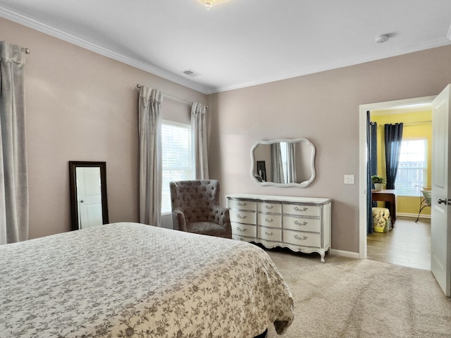 bedroom featuring multiple windows, crown molding, and light carpet