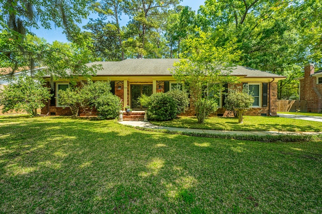 ranch-style home with a front lawn