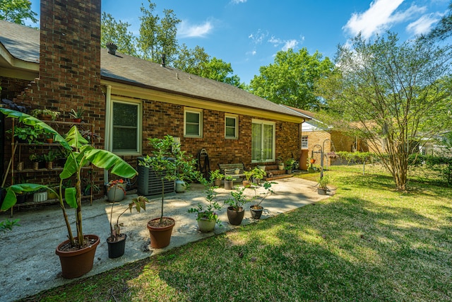 exterior space with central AC unit and a patio