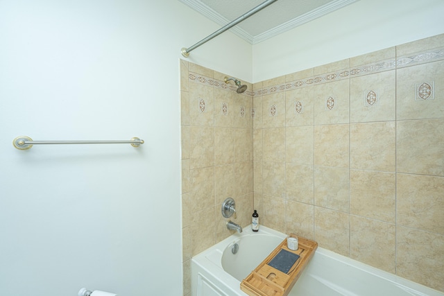 bathroom with tiled shower / bath combo and crown molding