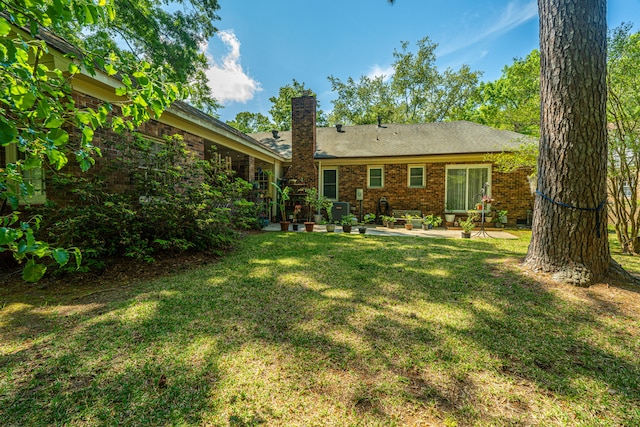 back of house featuring a yard and a patio area